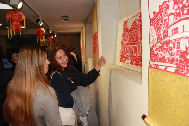 (251016) -- SOFIA, Oct. 16, 2025 (Xinhua) -- Visitors view posters with some of the images and texts included in the book "101 Paintings from Bulgaria" at its launch in Sofia, Bulgaria, on Oct. 16, 2025. The launch event for the bilingual book "101 Paintings from Bulgaria" was held at the Confucius Institute in Sofia here on Thursday.
   The book features 101 images of Bulgaria's most significant historical and architectural landmarks, depicted in traditional Chinese paper-cutting by a young Chinese artist, with accompanying texts in both Chinese and Bulgarian. (Photo by Marian Draganov/Xinhua)