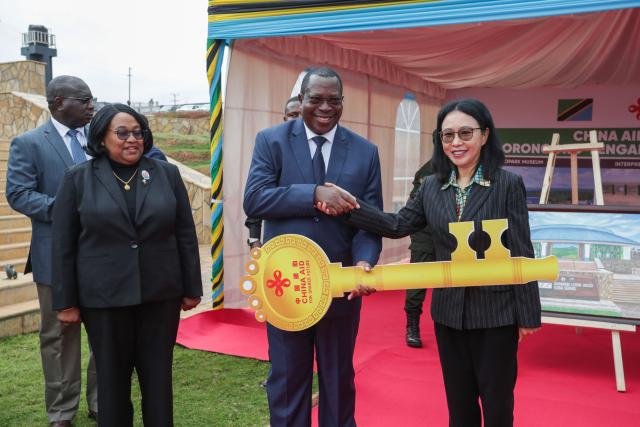 (251017) -- DAR ES SALAAM, Oct. 17, 2025 (Xinhua) -- Tanzanian Vice President Philip Mpango (2nd R) shakes hands with Chinese Ambassador to Tanzania Chen Mingjian (1st R) during the handover ceremony of the China-aided Ngorongoro-Lengai Geopark in Arusha, Tanzania, Oct. 16, 2025. TO GO WITH "China, Tanzania unveil landmark Ngorongoro-Lengai Geopark" (Xinhua/Emmanuel Herman)