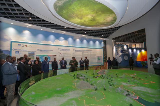 (251017) -- DAR ES SALAAM, Oct. 17, 2025 (Xinhua) -- Guests visit a sand table model of the China-aided Ngorongoro-Lengai Geopark at a newly inaugurated museum of the park in Arusha, Tanzania, Oct. 16, 2025. TO GO WITH "China, Tanzania unveil landmark Ngorongoro-Lengai Geopark" (Xinhua/Emmanuel Herman)