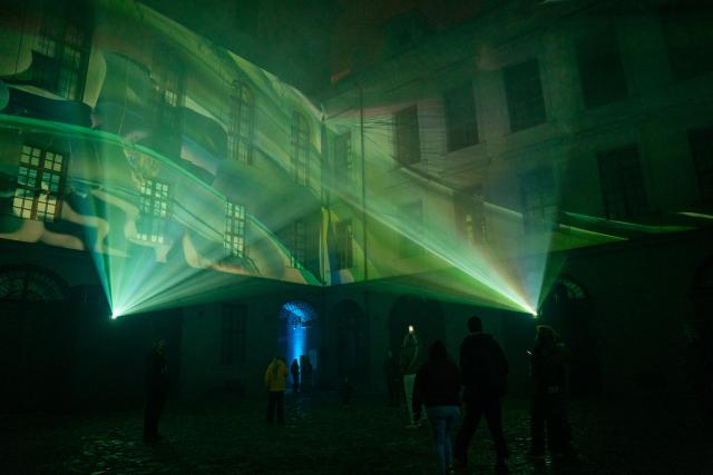 (251017) -- PRAGUE, Oct. 17, 2025 (Xinhua) -- Visitors watch a projection of video mapping during the Signal Festival in Prague, the Czech Republic, Oct. 17, 2025. The streets and historic landmarks of Prague have once again come alive with light and digital art as the 13th edition of the Signal Festival opened on Thursday evening. (Photo by Dana Kesnerova/Xinhua)