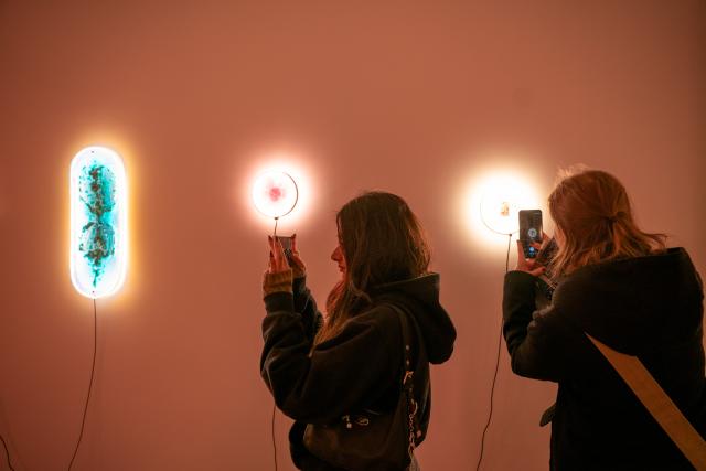(251017) -- PRAGUE, Oct. 17, 2025 (Xinhua) -- Visitors take photos of light installations during the Signal Festival in Prague, the Czech Republic, Oct. 17, 2025. The streets and historic landmarks of Prague have once again come alive with light and digital art as the 13th edition of the Signal Festival opened on Thursday evening. (Photo by Dana Kesnerova/Xinhua)