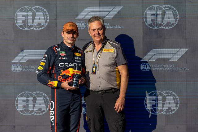 (251018) -- AUSTIN, Oct. 18, 2025 (Xinhua) -- Red Bull's Dutch driver Max Verstappen (L) poses with the sprint pole position award with Pirelli F1 Motorsport Director Mario Isola after the Qualifying for the Sprint race of the Formula One United States Grand Prix, in Austin, Texas, the United States, Oct. 17, 2025. (Photo by Song Haiyuan/Xinhua)