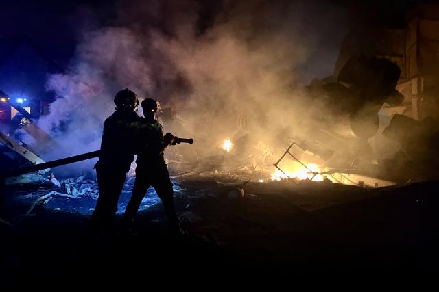 (251018) -- BEIJING, Oct. 18, 2025 (Xinhua) -- People attempt to put out the fire on a cement manufacturing complex following Israeli airstrikes in Ansar, Lebanon, on Oct. 16, 2025. (Photo by Ali Hashisho/Xinhua)