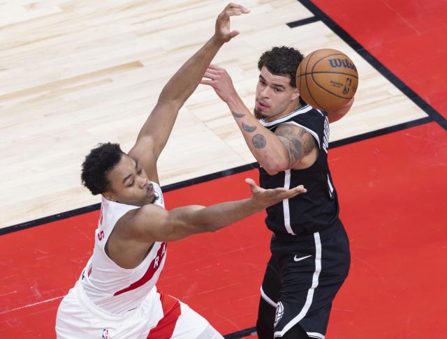 (251018) -- TORONTO, Oct. 18, 2025 (Xinhua) -- Scottie Barnes (L) of Toronto Raptors vies with Michael Porter Jr. of Brooklyn Nets during the 2025-2026 NBA preseason game between Toronto Raptors and Brooklyn Nets in Toronto, Canada, on Oct. 17, 2025. (Photo by Zou Zheng/Xinhua)