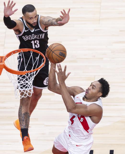 (251018) -- TORONTO, Oct. 18, 2025 (Xinhua) -- Scottie Barnes (bottom) of Toronto Raptors goes up for a layup during the 2025-2026 NBA preseason game between Toronto Raptors and Brooklyn Nets in Toronto, Canada, on Oct. 17, 2025. (Photo by Zou Zheng/Xinhua)