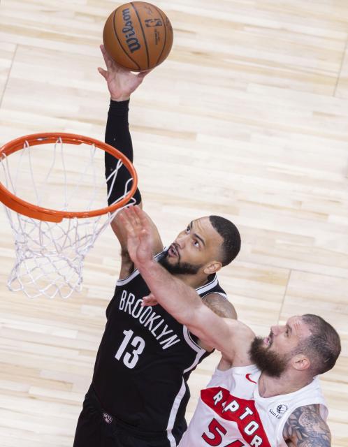 (251018) -- TORONTO, Oct. 18, 2025 (Xinhua) -- Tyrese Martin (L) of Brooklyn Nets goes up for a layup during the 2025-2026 NBA preseason game between Toronto Raptors and Brooklyn Nets in Toronto, Canada, on Oct. 17, 2025. (Photo by Zou Zheng/Xinhua)
