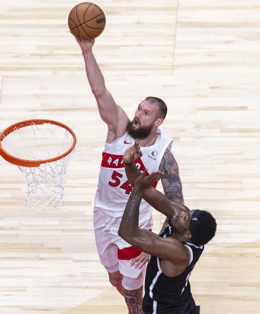 (251018) -- TORONTO, Oct. 18, 2025 (Xinhua) -- Sandro Mamukelashvili (top) of Toronto Raptors goes up for a layup during the 2025-2026 NBA preseason game between Toronto Raptors and Brooklyn Nets in Toronto, Canada, on Oct. 17, 2025. (Photo by Zou Zheng/Xinhua)