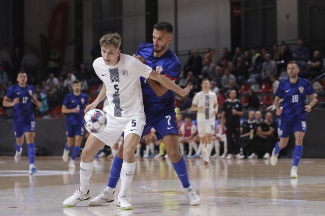 (251018) -- LJUBLJANA, Oct. 18, 2025 (Xinhua) -- Luka Cop (front L) of Slovenia competes during a friendly match before the UEFA Futsal Euro2026 between Slovenia and Croatia in Ljubljana, Slovenia, Oct. 17, 2025. (Photo by Zeljko Stevanic/Xinhua)