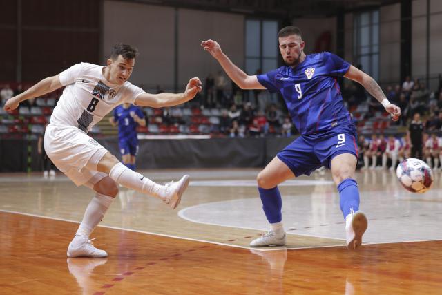 (251018) -- LJUBLJANA, Oct. 18, 2025 (Xinhua) -- Nejc Hozjan (L) of Slovenia shoots during a friendly match before the UEFA Futsal Euro2026 between Slovenia and Croatia in Ljubljana, Slovenia, Oct. 17, 2025. (Photo by Zeljko Stevanic/Xinhua)