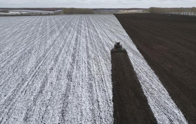 (251018) -- HARBIN, Oct. 18, 2025 (Xinhua) -- An aerial drone photo taken on Oct. 17, 2025 shows an agricultural machinery working in a snow-covered field of a farming company under Beidahuang Group in northeast China's Heilongjiang Province. As many areas in Heilongjiang Province have experienced snowfall, some agricultural production units of the Beidahuang Group have prepared the soil for winter before the ground freezes. (Photo by Xu Yingxian/Xinhua)