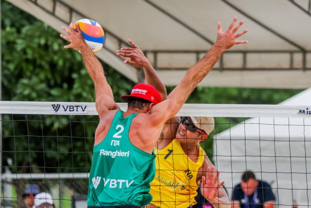 (251018) -- LAGUNA PROVINCE, Oct. 18, 2025 (Xinhua) -- Bintang Akbar (back) of Indonesia competes against Alex Ranghieri of Italy during the men's quarterfinal match between Manuel Alfieri/Alex Ranghieri of Italy and Bintang Akbar/Sofyan Rachman Efendi of Indonesia at the Volleyball World Beach Pro Tour in Laguna Province, the Philippines, Oct. 18, 2025. (Xinhua/Rouelle Umali)