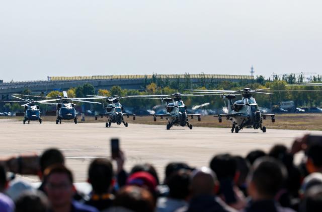 (251018) -- TIANJIN, Oct. 18, 2025 (Xinhua) -- Helicopters of the Fenglei aerobatic team of the Chinese People's Liberation Army (PLA) land after performance during the 7th China Helicopter Exposition in north China's Tianjin Municipality, Oct. 18, 2025. The exposition opened to the general public on Saturday. (Xinhua/Sun Fanyue)