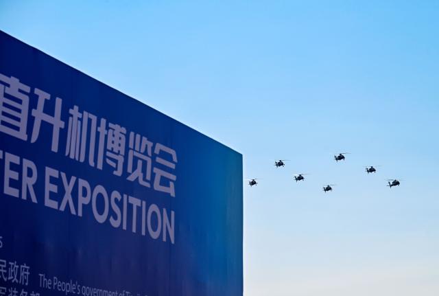 (251018) -- TIANJIN, Oct. 18, 2025 (Xinhua) -- Helicopters of the Fenglei aerobatic team of the Chinese People's Liberation Army (PLA) perform during the 7th China Helicopter Exposition in north China's Tianjin Municipality, Oct. 18, 2025. The exposition opened to the general public on Saturday. (Xinhua/Zhao Zishuo)