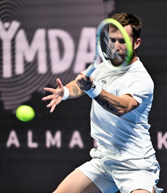 (251019) -- ALMATY, Oct. 19, 2025 (Xinhua) -- Corentin Moutet of France hits a return during the men's singles semifinal match against Alex Michelsen of the United States at the ATP 250 Almaty Tennis Open in Almaty, Kazakhstan, on Oct. 18, 2025. (Xinhua/Li Renzi)