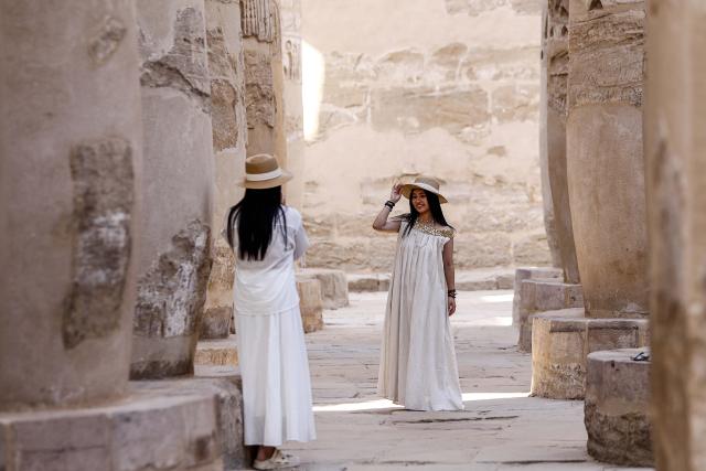 (251019) -- LUXOR, Oct. 19, 2025 (Xinhua) -- Chinese tourists take photos while touring the Karnak Temple Complex in Luxor, Egypt, on Oct. 5, 2025.
  TO GO WITH "Roundup: Chinese tourists help drive winter tourism revival in Egypt's Luxor " (Xinhua/Ahmed Gomaa)