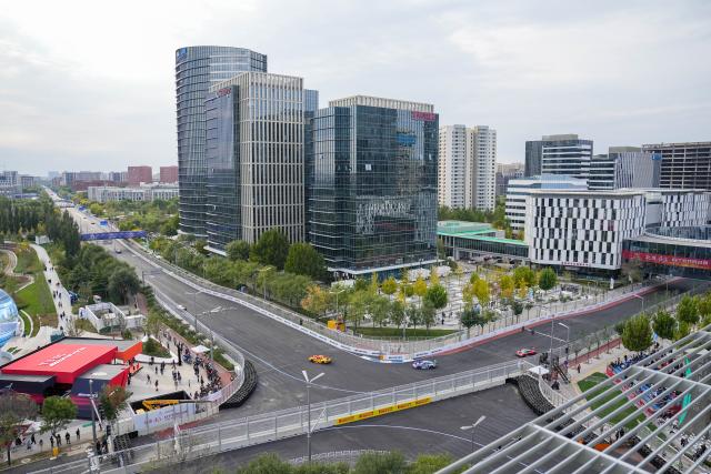(251018) -- BEIJING, Oct. 18, 2025 (Xinhua) -- Cars are seen during the qualifying session of GT World Challenge Asia at the Beijing Street Circuit in Beijing Economic-Technological Development Area (E-Town) of Beijing, China, Oct. 18, 2025. (Xinhua/Ju Huanzong)