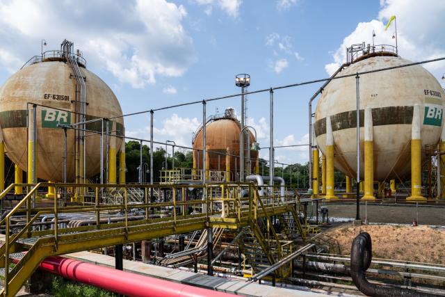 (251019) -- AMAZONAS, Oct. 19, 2025 (Xinhua) -- This photo taken on Oct. 16, 2025 shows liquefied petroleum gas storage tanks standing in the production area of the Urucu Oil and Gas Production Field in the state of Amazonas, Brazil.
  The Urucu Oil and Gas Production Field, located in the heart of Brazil's Amazonas state, is one of the country's most important onshore oil and gas production bases. 
  Surrounded by pristine rainforest, it has operated steadily since its start-up in 1988, supplying oil and natural gas that support energy needs across northern Brazil. 
  According to its operator Petrobras, the field has preserved about 98 percent of its area as native forest, carries out rainwater recycling, waste recovery, and reforestation programs and plants more than 1.5 million native trees. (Xinhua/Wang Tiancong)
