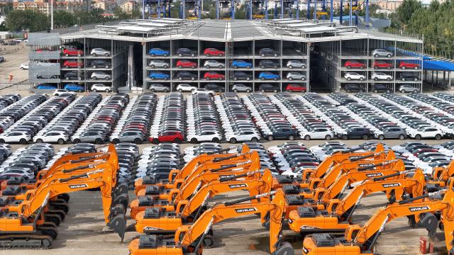(251020) -- BEIJING, Oct. 20, 2025 (Xinhua) -- A drone photo shows domestically produced cars and engineering machinery vehicles for export at Yantai Port in east China's Shandong Province, Oct. 20, 2025. China's gross domestic product (GDP) grew 5.2 percent year on year in the first three quarters of 2025, data from the National Bureau of Statistics (NBS) showed Monday. (Photo by Tang Ke/Xinhua)