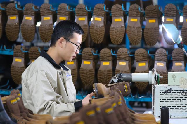 (251020) -- BEIJING, Oct. 20, 2025 (Xinhua) -- An employee processes a shoe at a company in Gaomi City, east China's Shandong Province, Oct. 20, 2025. China's gross domestic product (GDP) grew 5.2 percent year on year in the first three quarters of 2025, data from the National Bureau of Statistics (NBS) showed Monday. (Photo by Li Haitao/Xinhua)