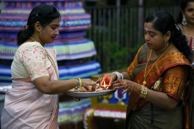 (251020) -- YANGON, Oct. 20, 2025 (Xinhua) -- Women light oil lamps to celebrate Diwali, or the Hindu festival of lights, at a Hindu temple in Yangon, Myanmar, Oct. 20, 2025. (Xinhua/Myo Kyaw Soe)