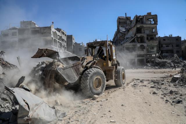 (251020) -- GAZA, Oct. 20, 2025 (Xinhua) -- A heavy machinery removes debris from a street in Gaza City, on Oct. 19, 2025. The Israel Defense Forces (IDF) said in a statement on Sunday that it had launched a new wave of strikes against Hamas militant targets in the southern Gaza Strip.
   According to the statement, the strikes were led by the IDF's Southern Command "following a ceasefire violation earlier in the day." (Photo by Rizek Abdeljawad/Xinhua)