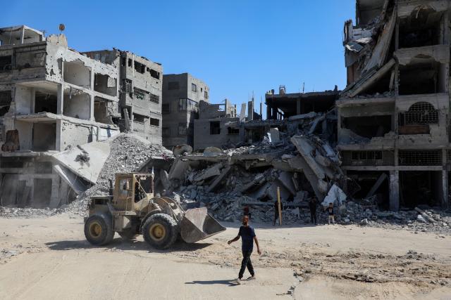 (251020) -- GAZA, Oct. 20, 2025 (Xinhua) -- A man walks on a street with destroyed buildings in Gaza City, on Oct. 19, 2025. The Israel Defense Forces (IDF) said in a statement on Sunday that it had launched a new wave of strikes against Hamas militant targets in the southern Gaza Strip.
   According to the statement, the strikes were led by the IDF's Southern Command "following a ceasefire violation earlier in the day." (Photo by Rizek Abdeljawad/Xinhua)