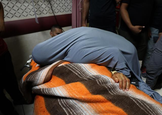 (251020) -- NABLUS, Oct. 20, 2025 (Xinhua) -- A relative mourns over a Palestinian man who was killed by the Israeli army in the West Bank city of Nablus, on Oct. 19, 2025. A Palestinian man was killed by the Israeli army in Nablus, the Palestinian Health Ministry reported on Sunday. (Photo by Nidal Eshtayeh/Xinhua)