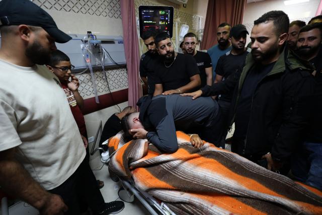 (251020) -- NABLUS, Oct. 20, 2025 (Xinhua) -- Relatives mourn over a Palestinian man who was killed by the Israeli army in the West Bank city of Nablus, on Oct. 19, 2025. A Palestinian man was killed by the Israeli army in Nablus, the Palestinian Health Ministry reported on Sunday. (Photo by Nidal Eshtayeh/Xinhua)