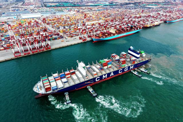 (251021) -- BEIJING, Oct. 21, 2025 (Xinhua) -- An aerial drone photo shows a cargo ship, assisted by tugboats, berthing at a container terminal of Qingdao Port in east China's Shandong Province, Oct. 20, 2025.
  China's gross domestic product (GDP) grew 5.2 percent year on year in the first three quarters of 2025, data from the National Bureau of Statistics (NBS) showed Monday. (Photo by Yu Fangping/Xinhua)