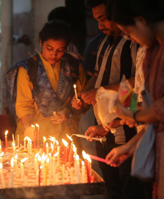 (251021) -- DHAKA, Oct. 21, 2025 (Xinhua) -- People light candles to celebrate Diwali, or the Hindu festival of lights, at a temple in Dhaka, Bangladesh on Oct. 20, 2025. (Photo by Habibur Rahman/Xinhua)