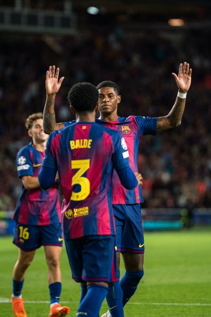 (251022) -- BARCELONA, Oct. 22, 2025 (Xinhua) -- Marcus Rashford (R) of FC Barcelona celebrates a goal with his teammates during the Champions League football match between FC Barcelona and Olympiacos in Barcelona, Spain, Oct. 21, 2025. (Photo by Joan Gosa/Xinhua)