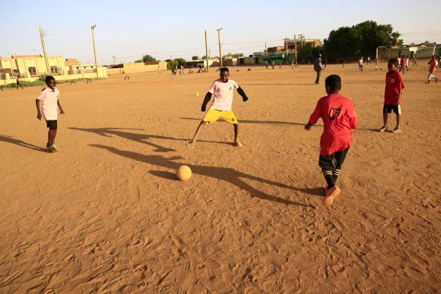 (251022) -- KHARTOUM, Oct. 22, 2025 (Xinhua) -- Children play football on a dirt field at Al-Iskan neighborhood, District 95, west of Omdurman, Sudan, on Oct. 19, 2025. TO GO WITH "Feature: In Khartoum, football on dirt fields offers therapy for war trauma" (Photo by Mohamed Khidir/Xinhua)