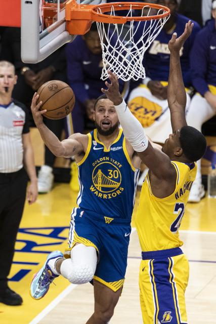 (251022) -- LOS ANGELES, Oct. 22, 2025 (Xinhua) -- Golden State Warriors' Stephen Curry (L) goes to the basket during the 2025-2026 NBA regular season match between Los Angeles Lakers and Golden State Warriors in Los Angeles, the United States, Oct. 21, 2025. (Photo by Ringo Chiu/Xinhua)