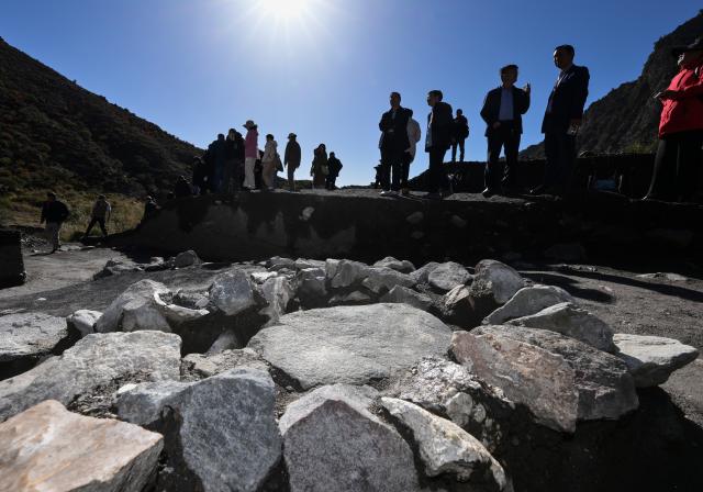 (251022) -- YINCHUAN, Oct. 22, 2025 (Xinhua) -- Archaeologists inspect a quartz processing site at the remnants of the Suyukou kiln in Yinchuan, capital of northwest China's Ningxia Hui Autonomous Region, Oct. 13, 2025. Remnants of the Suyukou kiln were discovered in 2017 in Yinchuan, capital of Ningxia, and cover an area of roughly 40,000 square meters.
   From 2021 to 2025, archaeologists from the Ningxia Institute of Cultural Relics and Archaeology and Fudan University found remnants of workshops featuring eight furnaces, as well as pits where workers used to mine porcelain clay, coal, quartz, lime and other raw materials and fuels, which were needed to make porcelain. 
   The Suyukou site is believed to be the earliest Western Xia Dynasty kiln site found to date in China. Judging from its production scale and saggars marked with the character guan, which literally means official, archaeologists believe that the Suyukou kiln was an official kiln producing bowls, cups, plates and other daily utensils -- mainly for the royal family during the Western Xia Dynasty (1038-1227). (Xinhua/Li He)