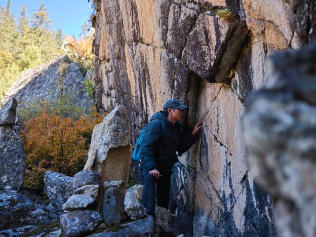 (251022) -- CHENGDU, Oct. 22, 2025 (Xinhua) -- Chen Xuesong, a cultural heritage conservator, checks a rock painting in Garze Tibetan Autonomous Prefecture, southwest China's Sichuan Province, Oct. 21, 2025. This group of rock paintings in the prefecture dates back about 8,000 years. (Xinhua/Xue Chen)