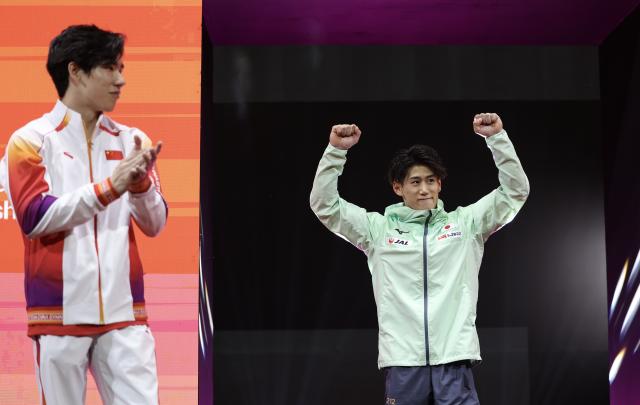 (251022) -- JAKARTA, Oct. 22, 2025 (Xinhua) -- Silver medalist Zhang Boheng (L) of China congratulates gold medalist Hashimoto Daiki of Japan during the awarding ceremony for Men's All-Round at the 53rd FIG Artistic Gymnastics World Championships in Jakarta, Indonesia, on Oct. 22, 2025. (Xinhua/Bai Xuefei)