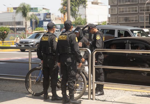 (251023) -- LIMA, Oct. 23, 2025 (Xinhua) -- Police officers ask a pedestrian for identification near the La Cultura metro station in Lima, Peru, on Oct. 22, 2025. Peruvian President Jose Jeri declared on Tuesday a 30-day state of emergency for the capital Lima and the neighboring Callao region to tackle worsening public security. (Xinhua/Mariana Bazo)