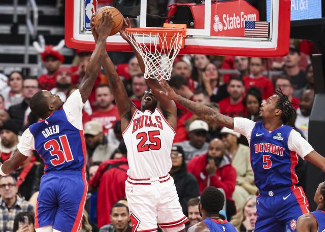 (251023) -- CHICAGO, Oct. 23, 2025 (Xinhua) -- Detroit Pistons' Javonte Green (L) and Ronald Holland II (R) defend against Chicago Bulls' Jalen Smith during the NBA regular season basketball game between Detroit Pistons and Chicago Bulls at the United Center in Chicago, the United States, on Oct. 22, 2025. (Photo by Joel Lerner/Xinhua)