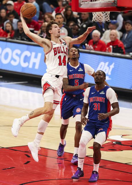 (251023) -- CHICAGO, Oct. 23, 2025 (Xinhua) -- Chicago Bulls' Matas Buzelis (L) rises to dunk the ball during the NBA regular season basketball game between Detroit Pistons and Chicago Bulls at the United Center in Chicago, the United States, on Oct. 22, 2025. (Photo by Joel Lerner/Xinhua)