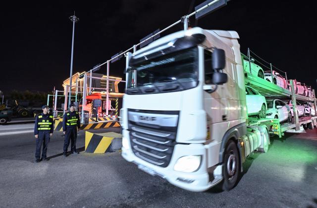 (251023) -- URUMQI, Oct. 23, 2025 (Xinhua) -- An outbound freight vehicle leaves the road port of Horgos, northwest China's Xinjiang Uygur Autonomous Region, Sept. 10, 2025. In the first three quarters of this year, the region's import and export value surged to 393.14 billion yuan (about 55.19 billion U.S. dollars), marking a 22.1 percent year on year increase, according to Urumqi Customs. (Xinhua/Li He)