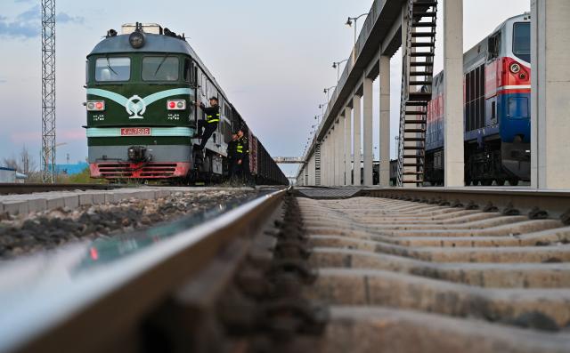 (251023) -- URUMQI, Oct. 23, 2025 (Xinhua) -- Customs staff check a China-Europe freight train parking at the Horgos railway port in Horgos, northwest China's Xinjiang Uygur Autonomous Region, Sept. 10, 2025. In the first three quarters of this year, the region's import and export value surged to 393.14 billion yuan (about 55.19 billion U.S. dollars), marking a 22.1 percent year on year increase, according to Urumqi Customs. (Xinhua/Li He)