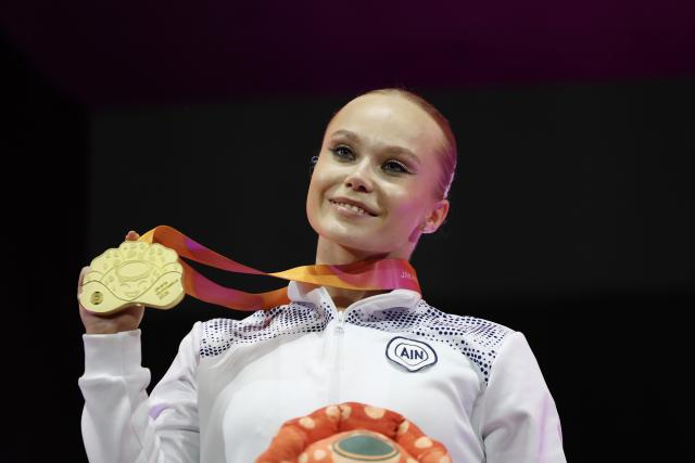 (251023) -- JAKARTA, Oct. 23, 2025 (Xinhua) -- Gold medalist Angelina Melnikova of AIN (Individual Neutral Athlete) poses on the podium during the awarding ceremony for the Women's All-Round Final at the 53rd FIG Artistic Gymnastics World Championships in Jakarta, Indonesia, on Oct. 23, 2025. (Xinhua/Bai Xuefei)