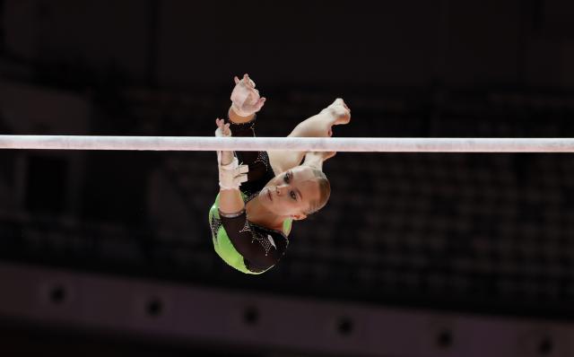 (251023) -- JAKARTA, Oct. 23, 2025 (Xinhua) -- Angelina Melnikova of AIN (Individual Neutral Athlete) competes during the Uneven Bars of the Women's All-Round Final at the 53rd FIG Artistic Gymnastics World Championships in Jakarta, Indonesia, on Oct. 23, 2025. (Xinhua/Bai Xuefei)