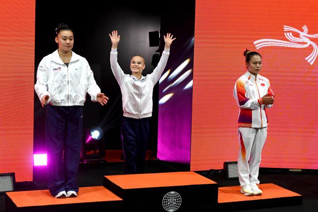(251023) -- JAKARTA, Oct. 23, 2025 (Xinhua) -- Gold medalist Angelina Melnikova (C) of AIN (Individual Neutral Athlete), silver medalist Leanne Wong (L) of the United States and bronze medalist Zhang Qingying of China attend the awarding ceremony for the Women's All-Round at the 53rd FIG Artistic Gymnastics World Championships in Jakarta, Indonesia, on Oct. 23, 2025. (Xinhua/Agung Kuncahya B.)