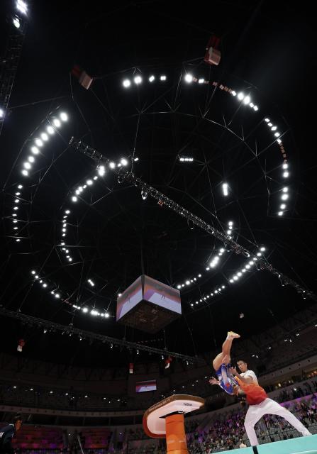 (251023) -- JAKARTA, Oct. 23, 2025 (Xinhua) -- Zhang Qingying (L) of China warms up before the Vault of the Women's All-Round Final at the 53rd FIG Artistic Gymnastics World Championships in Jakarta, Indonesia, on Oct. 23, 2025. (Xinhua/Bai Xuefei)