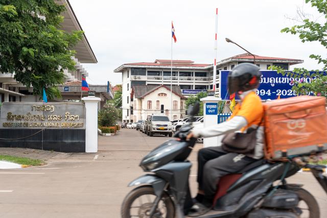 (251023) -- VIENTIANE, Oct. 23, 2025 (Xinhua) -- A motorbike passes by the Ministry of Education and Sports in Vientiane, Laos, Oct. 23, 2025. TO GO WITH "Roundup: Laos strives to enhance education for better future " (Photo by Kaikeo Saiyasane/Xinhua)