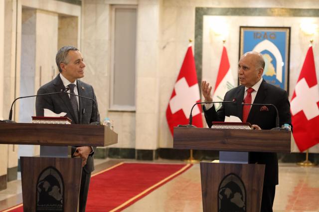 (251023) -- BAGHDAD, Oct. 23, 2025 (Xinhua) -- Iraqi Foreign Minister Fuad Hussein (R) and Swiss Federal Councilor and Foreign Minister Ignazio Cassis (L) attend a joint press conference in Baghdad, Iraq, Oct.23, 2025. Iraqi Prime Minister Mohammed Shia' al-Sudani met with a high-level Swiss delegation on Thursday to discuss enhancing bilateral cooperation and attracting Swiss investment in major Iraqi development projects, notably the Development Road initiative. (Xinhua/Khalil Dawood)