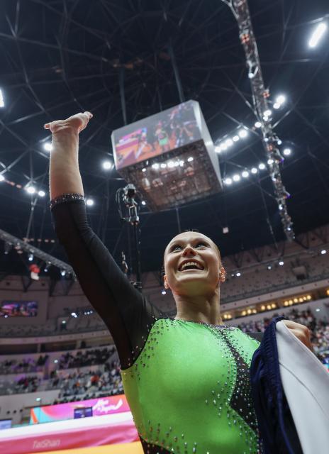 (251024) -- JAKARTA, Oct. 24, 2025 (Xinhua) -- Angelina Melnikova of AIN (Individual Neutral Athlete) gestures after winning the Women's All-Round Final at the 53rd FIG Artistic Gymnastics World Championships in Jakarta, Indonesia, on Oct. 23, 2025. (Xinhua/Bai Xuefei)