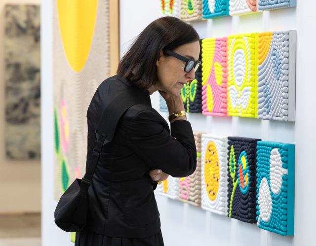 (251024) -- TORONTO, Oct. 24, 2025 (Xinhua) -- A woman looks at an artwork during the Art Toronto 2025 in Toronto, Canada, Oct. 23, 2025. Featuring over 100 international galleries, installations, project spaces and more, the art fair is held here from Oct. 23 to 26. (Photo by Zou Zheng/Xinhua)
