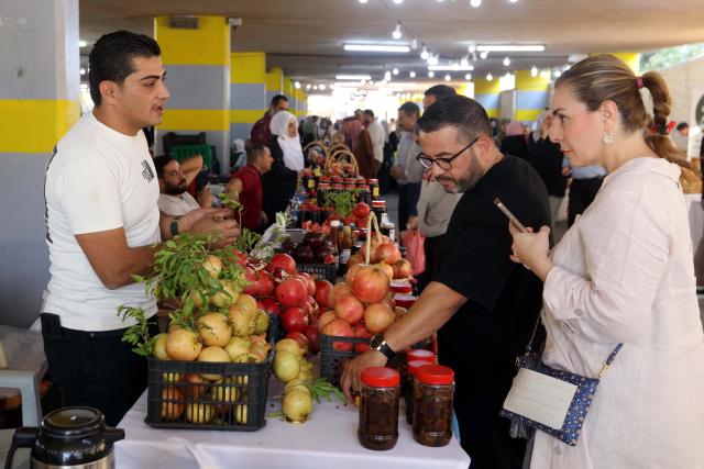 (251024) -- IRBID, Oct. 24, 2025 (Xinhua) -- People visit the 17th Annual Pomegranate and Rural Products Festival in Irbid, Jordan, Oct. 23, 2025. The festival kicked off here on Thursday. (Photo by Mohammad Abu Ghosh/Xinhua)